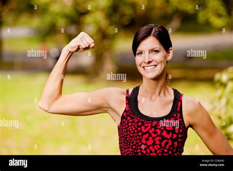 A Pretty Fitness Model Flexing Her Bicep Stock Photo Alamy