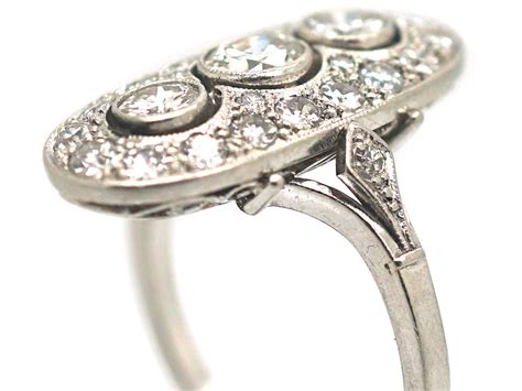 Art Deco Platinum And Diamond Oval Shaped Ring With Three Diamonds Down