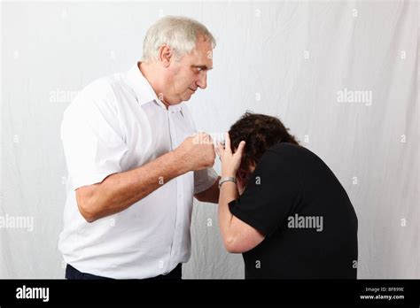Grey Haired Late Middle Aged Married Man Husband Punches Wife Woman Illustrating Domestic