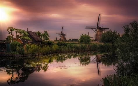 Windmills At Kinderdijk In The Province Of South Holland Netherlands Sunset Dusk Channel ...