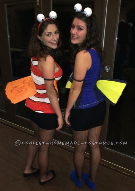 Two Women Dressed Up In Costumes Standing Next To Each Other