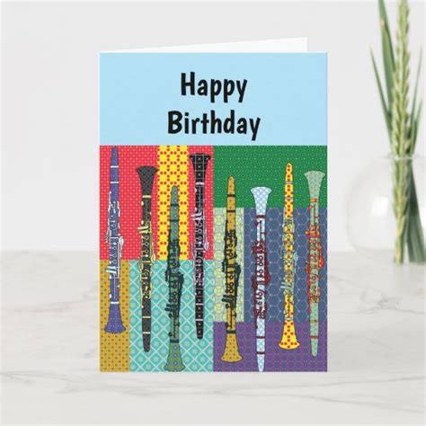 A Happy Birthday Card With Colorful Flutes In Front Of A Vase Filled