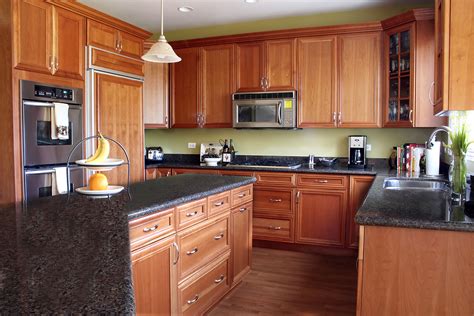 If your cabinets are wood and you're comfortable with their style, you can sand them down and then repaint, stain or refinish them. Remodeling Your Kitchen? Tips on How to Save Money ...