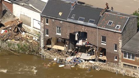 Footage Shows Damaged Homes And Debris Lined Streets Along River After