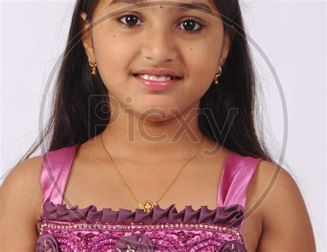 Image Of Portrait Of A Cute And Chubby Indian Girl Child With Smile