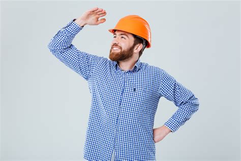 happy bearded young man  helmet standing      white background royalty