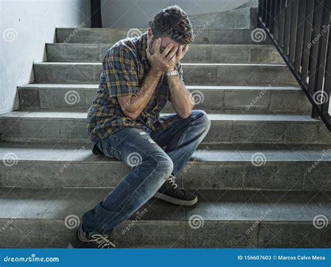 Dramatic Lifestyle Portrait Of Young Depressed And Sad Man Sitting