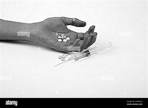 Drug Addiction Concept Passive Hand With Coat Pills And Injection