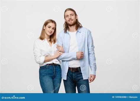 Portrait Of Attractive Young Couple Smiling For The Camera While