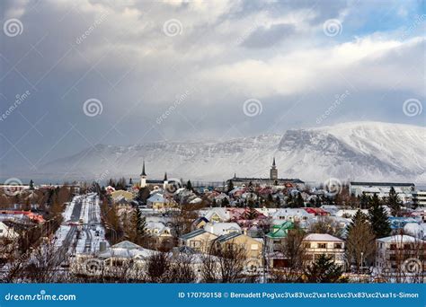 View Of Reykjavik From The Hill With Snowy Mountains In Winter Stock