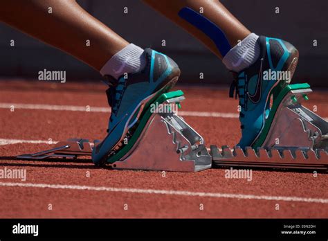 Female African American Runners Feet In A Set Of Starting Blocks On A