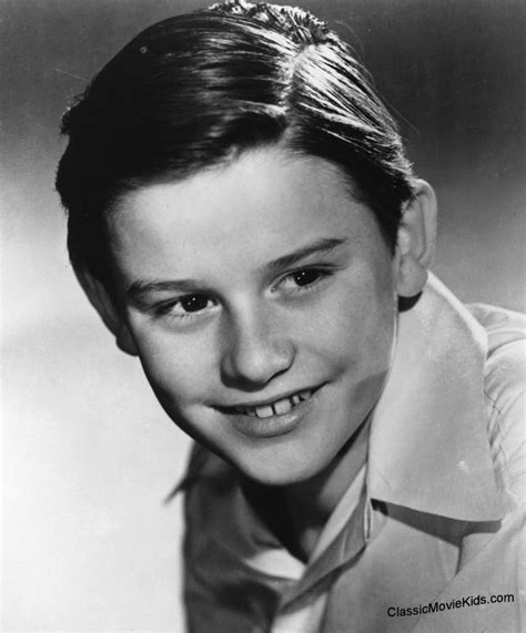 A Black And White Photo Of A Young Boy