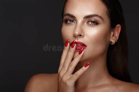 Beautiful Girl With A Classic Make Up And Red Nails Manicure Design