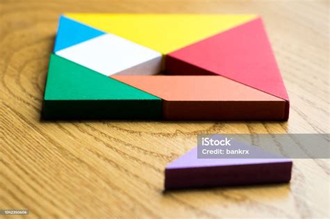 Tangram Puzzle In Square Shape That Wait For Complete On Wood