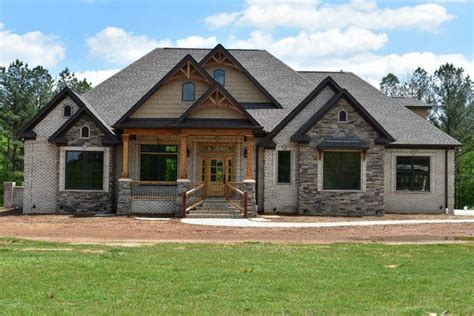 A Large House With Stone And Wood Accents