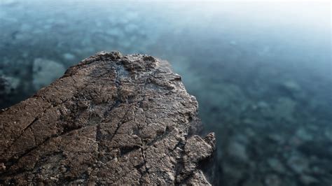 Shallow Focus Photography Of Grey Cliff Depth Of Field Rock Water