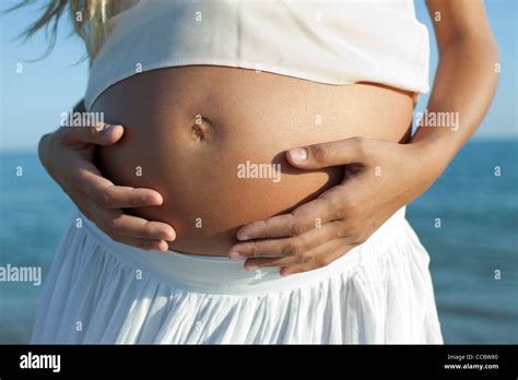 Woman S Hands On Pregnant Belly Cropped Stock Photo Alamy