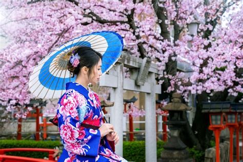 free photo asian woman wearing japanese traditional kimono and cherry blossom in spring kyoto