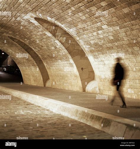 Person Walking Through Tunnel At Night Stock Photo Alamy