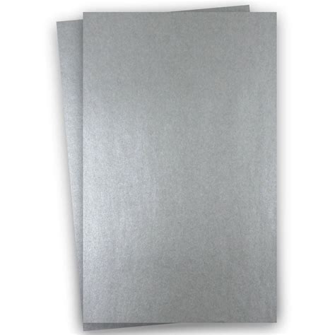 Two Pieces Of Silver Colored Paper On A White Background