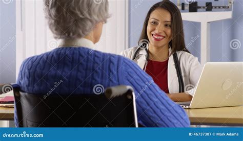 Happy Hispanic Doctor Talking With Senior Patient Stock Image Image