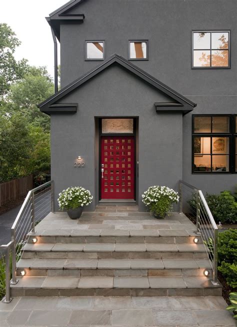 Stone Steps Lead To A Contemporary Red Door With Unique Window Cutouts