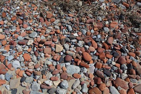 A Selection Of Rocks And Pebbles On The Sand At The Beach Stock Photo