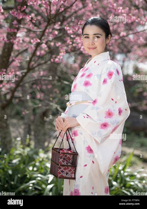 Young Asian Caucasian Japanese Woman In Yukata With Cherry