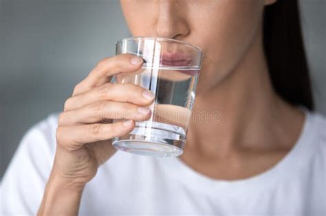 Close Up Woman Drinking Pure Water Holding Glass In Hand Stock Image
