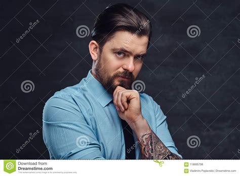 Check spelling or type a new query. Portrait Of A Tattooed Handsome Middle-aged Man With Beard And Hairstyle Dressed In A Blue Shirt ...