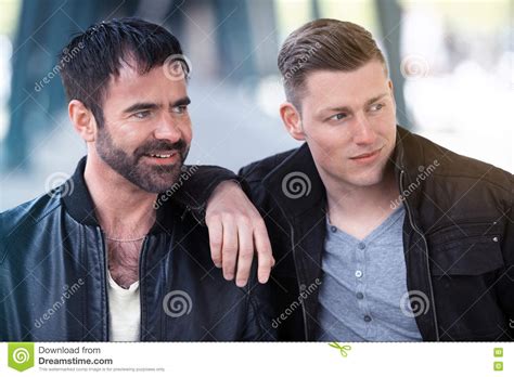 Two Men Standing And Hugging Each Other Stock Image