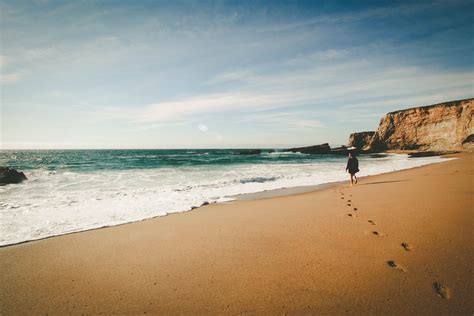 Lone Woman Enjoys Walk On The Beach In Idyllic Paradise View Woman In Beach Paradise 4k Hd