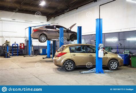 Car On Lift In Mechanic Shop Or Garage Interior Of Auto Repair