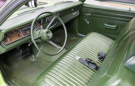The Interior Of An Old Car With Green Leather