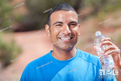 Smiling Man Drinking Water After Jogging Stock Photo Picture And