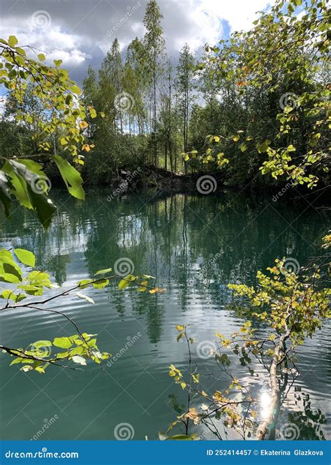 Lake With A Turquoise Water And Stone Shores Overgrown With Forest