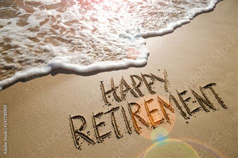 Happy Retirement Message Handwritten On Smooth Sand Beach With Gentle