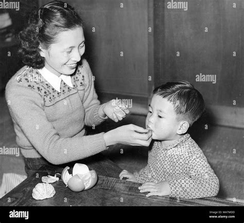 1950s Japan Japanese Mother And Son — Mother Feeding Mikan