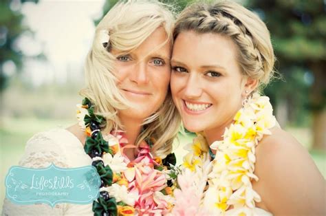 bride and mom with leis after the wedding bride wedding mom