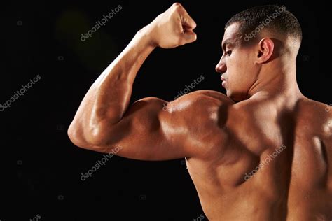 Male Bodybuilder Flexing Bicep ⬇ Stock Photo Image By © Monkeybusiness
