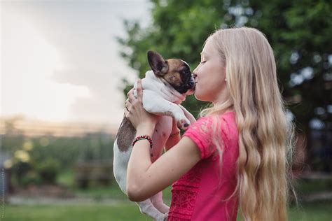 Young Girl Kissing Her Puppy By Stocksy Contributor Mauro Grigollo