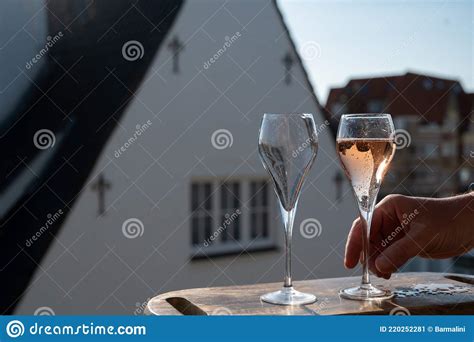Pouring Of Rose Champagne Sparkling Wine In Flute Glasses On Outdoor
