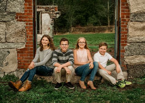 Four siblings sit outside on step of building ruins | Family photos ...