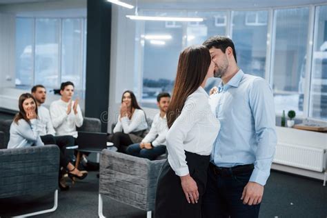 spontaneous lovely kiss between two employees shocked other office workers stock image image