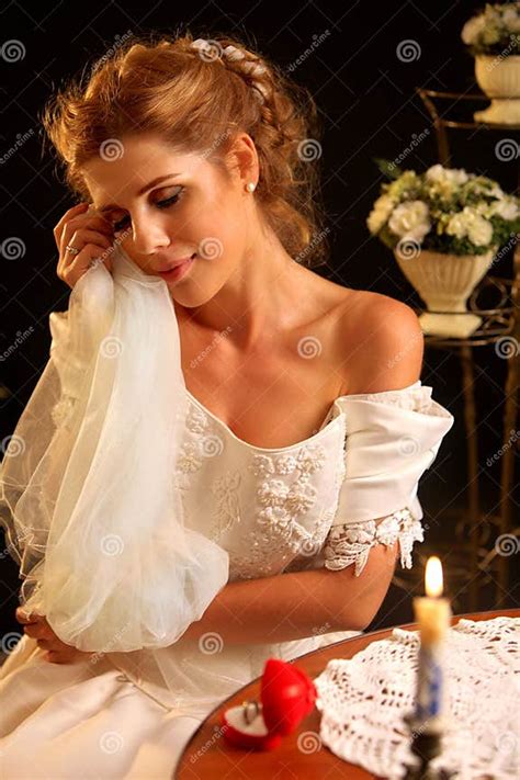 Bride In Wedding Dress Holding Veil Girl Undresses For Night Stock