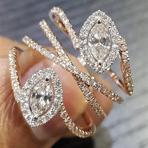 an intricate halo of pavé set diamonds embraces and accentuates the center marquise of this br