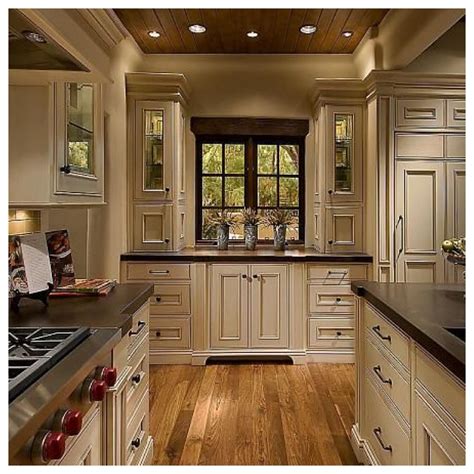 White and light colored floors create contrast, break off heaviness and introduce balance between the dark colored cabinetry. All The Pretty Things