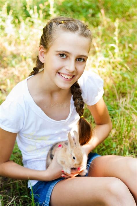 Cute Little Girl With A Rabbit In The Garden Stock Photo Image Of