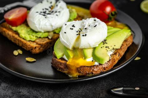 Poached Egg On Toast Sandwich With Avocado And Poached Egg Stock Photo
