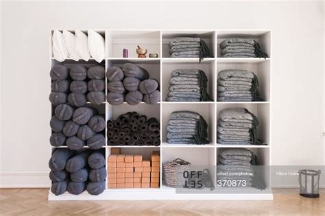 Shelves Of Mats Blocks And Bolsters In Yoga Studio Stock Photo